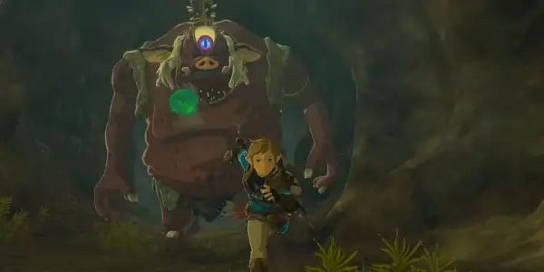 Link poursuivi par un Hinox à travers un tunnel dans The Legend of Zelda : Tears of the Kingdom.