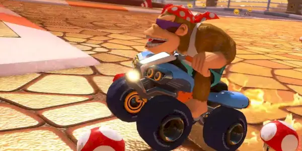 Diddy Kong dirigindo uma bicicleta azul Mario Kart 8 Deluxe DLC.