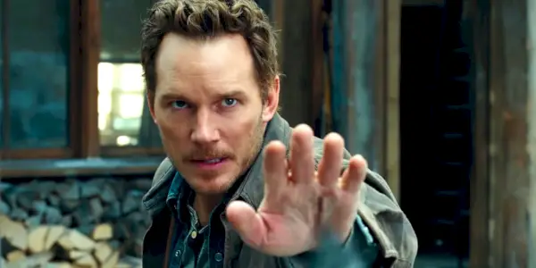 Chris Pratt podnosi rękę w Jurassic World Dominion