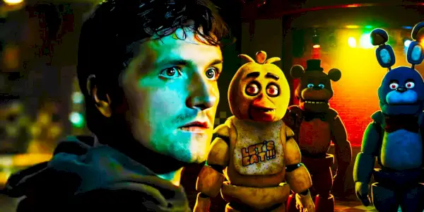 Josh Hutcherson ako Mike sa pozerá cez rameno, zatiaľ čo za ním číhajú animatronici FNAF vo filme Five Nights at Freddy