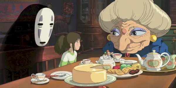 No-Face a Chihiro sedia pri stole so Zenibou na čaji a občerstvení v Spirited Away.