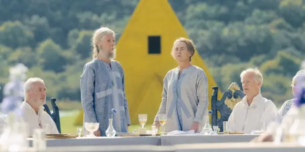 Dan i Ylga stoją podczas sceny kolacji w Midsommarze