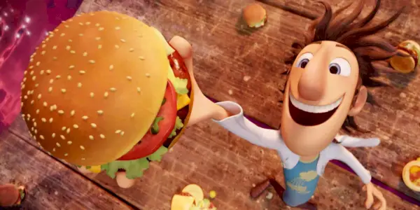 Flint souriant avec un hamburger à la main dans Cloudy with a Chance of Meatballs