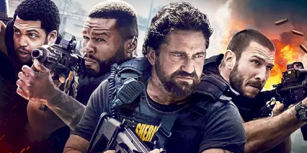 Les acteurs de Den of Thieves posent avec une arme à feu sur une image promotionnelle