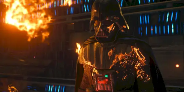 Dark Vador tel qu'il apparaît dans Star Wars Jedi : Survivor, avec une partie de son costume en feu alors qu'il affronte Cere Junda dans ses archives en feu sur Jedha.