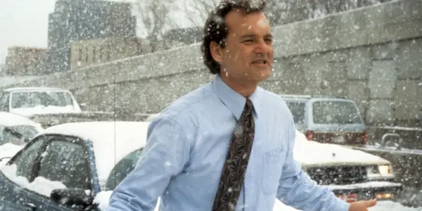 Phil (Bill Murray) traverse la circulation dans la neige dans Groundhog Day.