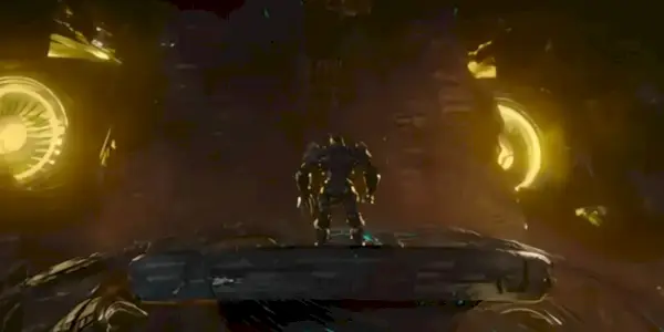 Unicron apre gli occhi mentre Scourge è di fronte a lui in Transformers: L'Ascesa delle Bestie