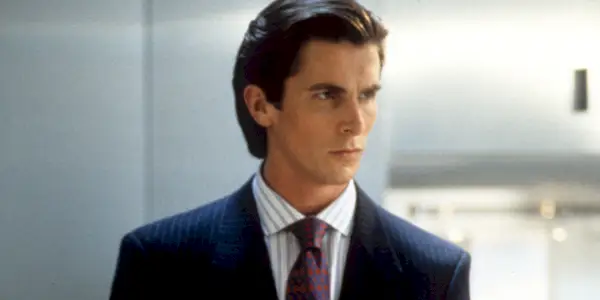 Christian Bale jako Patrick Bateman wygląda poważnie w „American Psycho”.