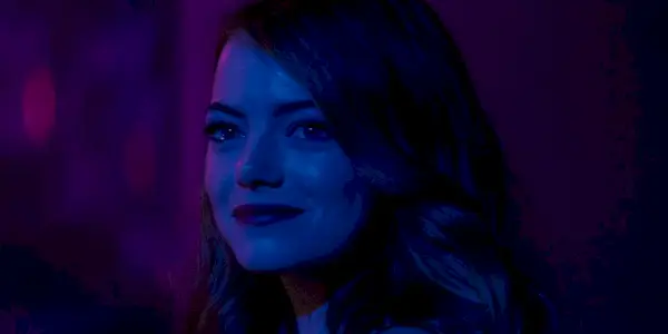 Emma Stone como Mia mirando hacia atrás y sonriendo en La La Land