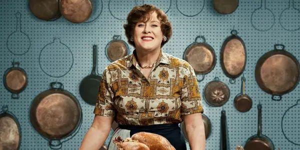 Julia smiling in front of pans in Julia