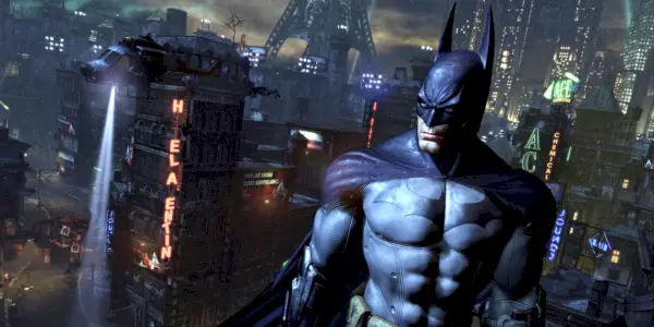 Batman debout devant les toits d'Arkham City.