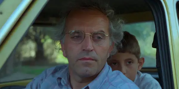 And Life Goes On 1992 Man with a child in the back of the car in Iran